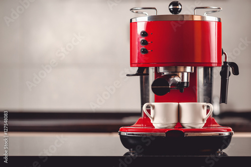 Canvas Print An espresso machine and two cups