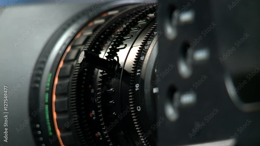 Professional camcorder lens on dark background, macro