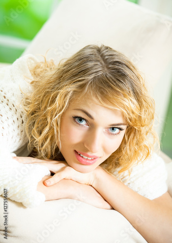 Portrait of young happy smiling woman waking up at bedroom