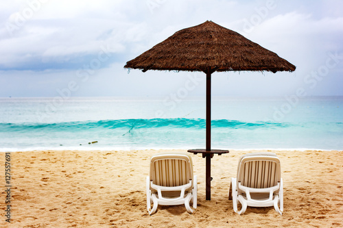 Sandy coastine with chaise-longue