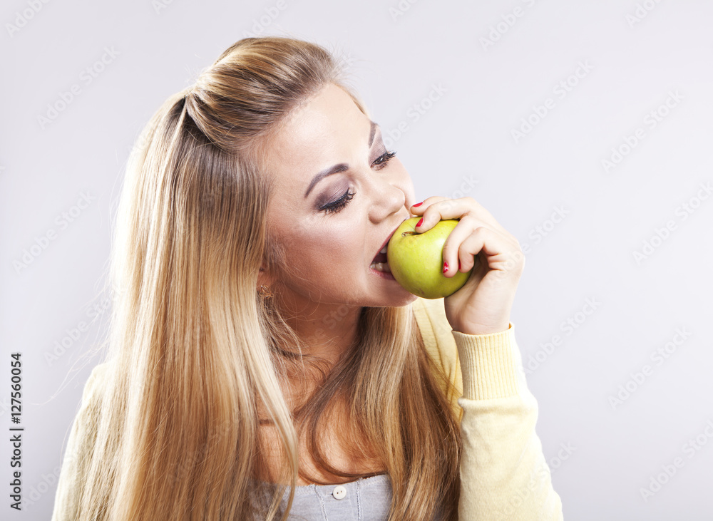 Smiling girl with green apple. Broad smile. Healthy teeth
Smiling girl with green apple. Broad smile. Healthy teeth