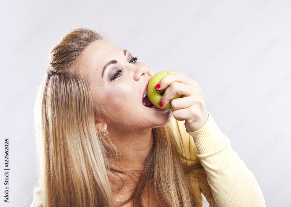 Smiling girl with green apple. Broad smile. Healthy teeth
Smiling girl with green apple. Broad smile. Healthy teeth
