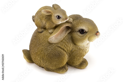 Photo of statuettes of grey and white rabbits with gifts isolated on a white background © Ivan