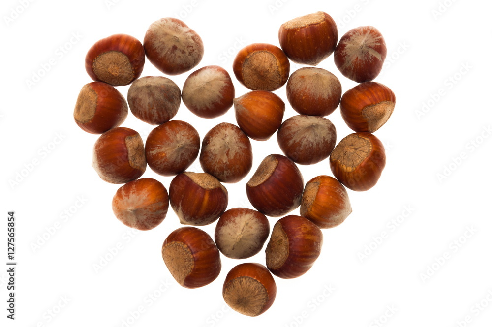 Hazelnuts in heart-shape on white background. Valentine's Day. Hazelnuts in heart-shape on white background. Valentine's Day.