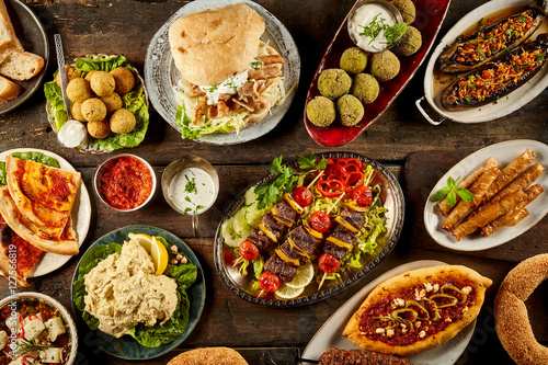 Various Mediterranean dishes and bread on table