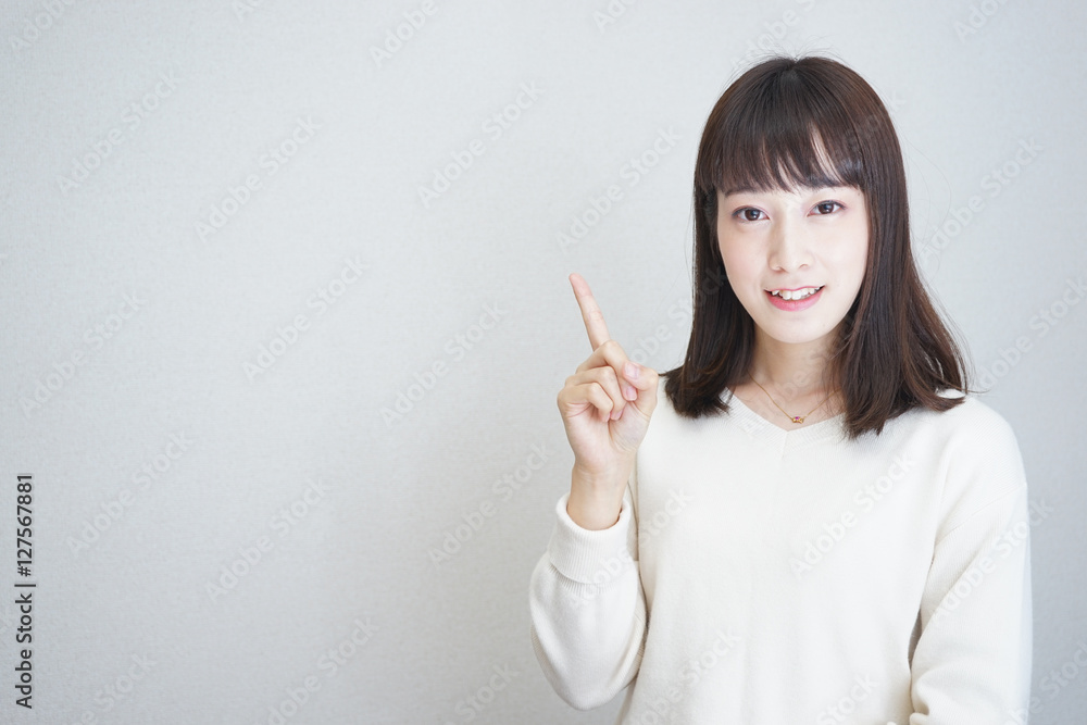 Young woman pointing something with smile Young woman pointing something with smile