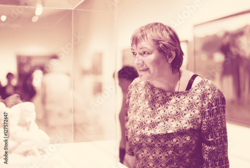 Closeup on attentive senior woman visiting museum