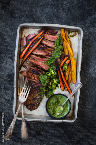 Ostrich fillet and roasted vegetables. Beef steak and roasted vegetables. Dinner table with ostrich fillet and roasted vegetables. 