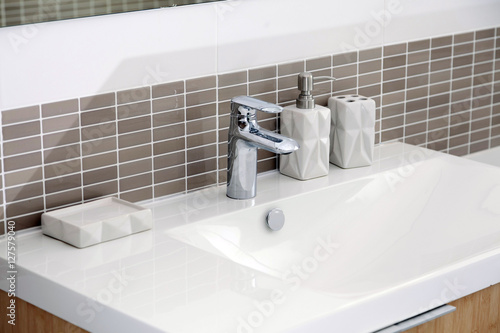 Fototapeta White sink and dispenser in bathroom