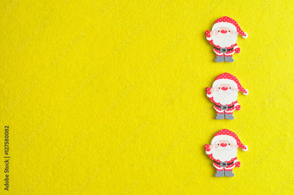 Row of Santa clauses isolated on a yellow background