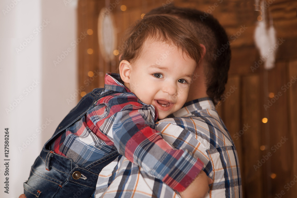 Sad little child boy, hugging his father at home. Family concept
Sad little child boy, hugging his father at home. Family concept