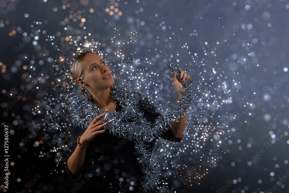 Portrait of beautiful young blond woman with tinsel, happy and smiling Portrait of beautiful young blond woman with tinsel, happy and smiling