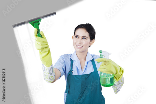Housekeeper cleaning the glass with cleaner tools