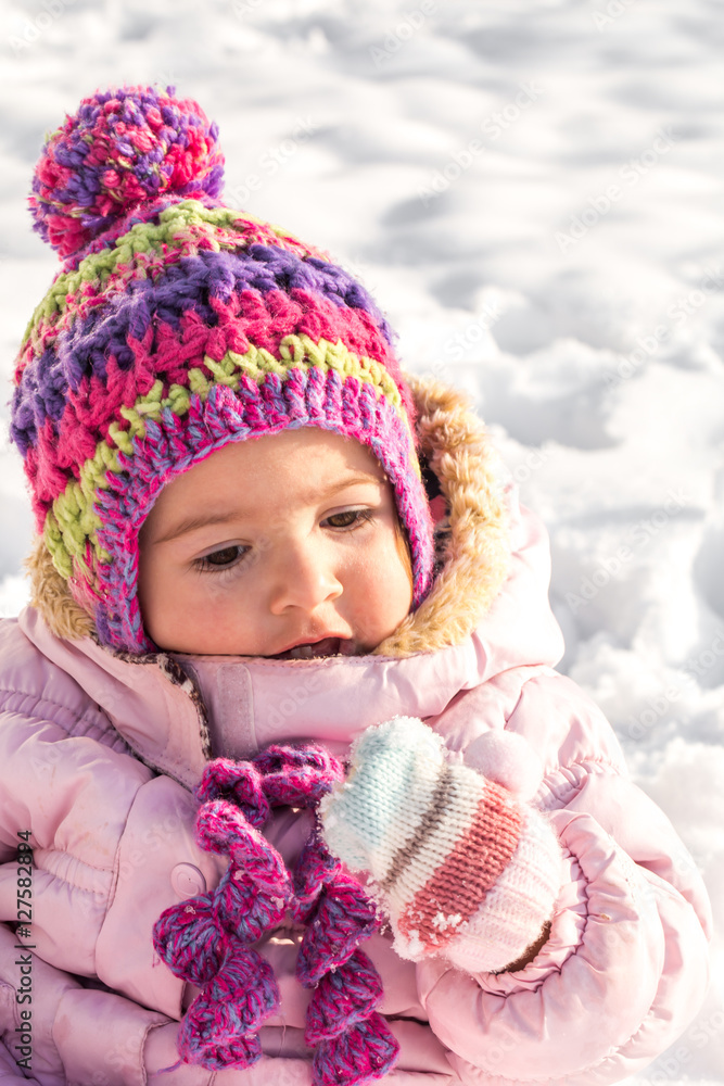 beautiful little girl playing in the snow