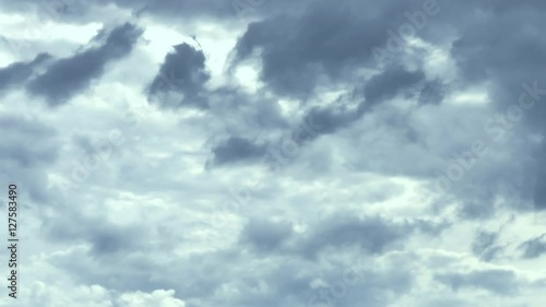 Loopable: Time lapse of clouds during a severe thunderstorm with lightning strikes in the daytime. The sky becomes darker and lighter over time. Seamless loop.