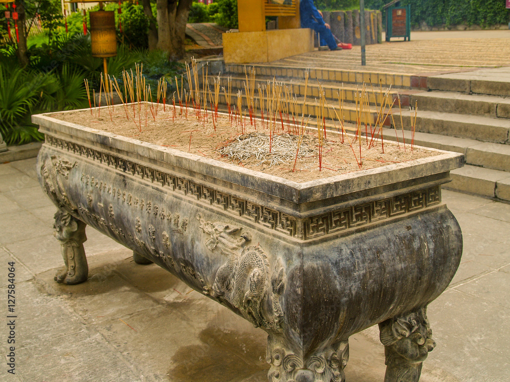 Aroma sticks stand near Buddhist temple