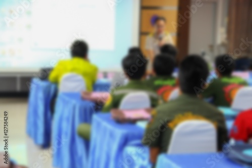 blurred focus, student learning business sitting in classroom with teacher front 
