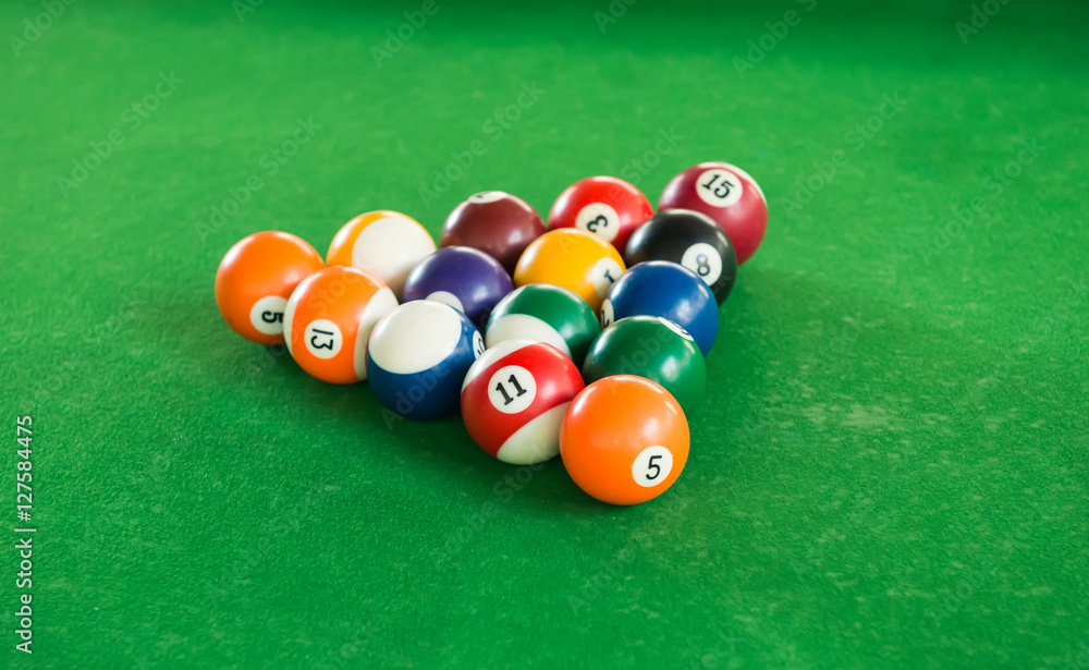 Billiard balls composition on green pool table Billiard balls composition on green pool table