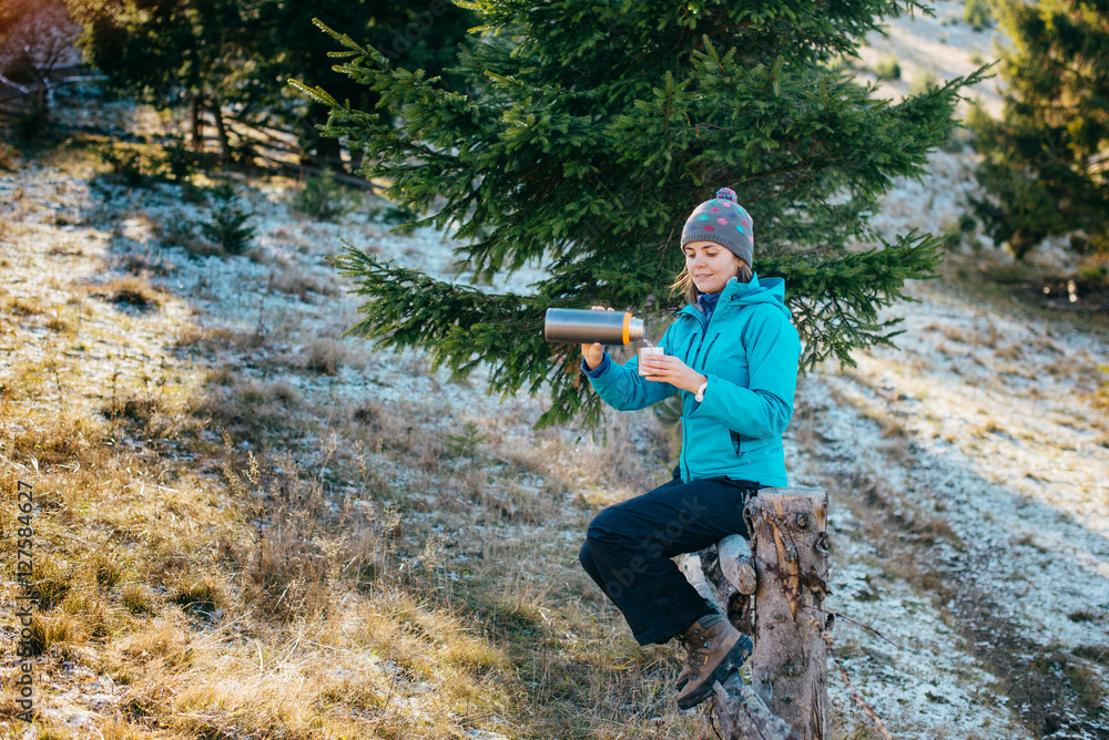 Girl in bright sport clothes drinking a delicious tea while walk Girl in bright sport clothes drinking a delicious tea while walk