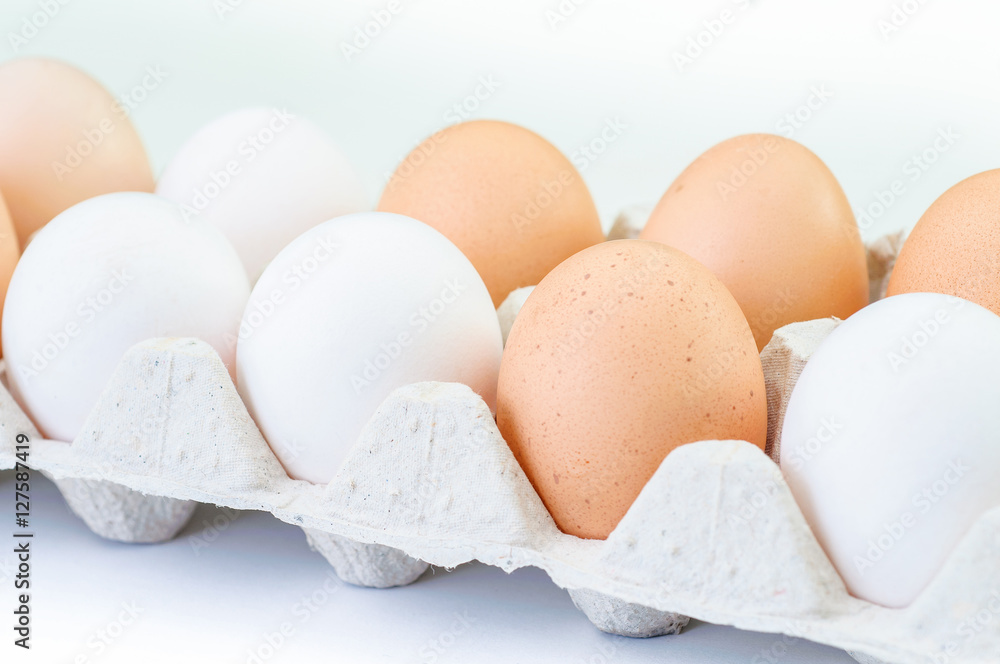 Different eggs in carton pack isolated on white Different eggs in carton pack isolated on white