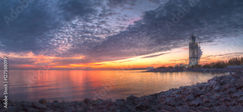 Panoramic view of beautiful sunset with scarlet clouds above the Gulf of Finland.