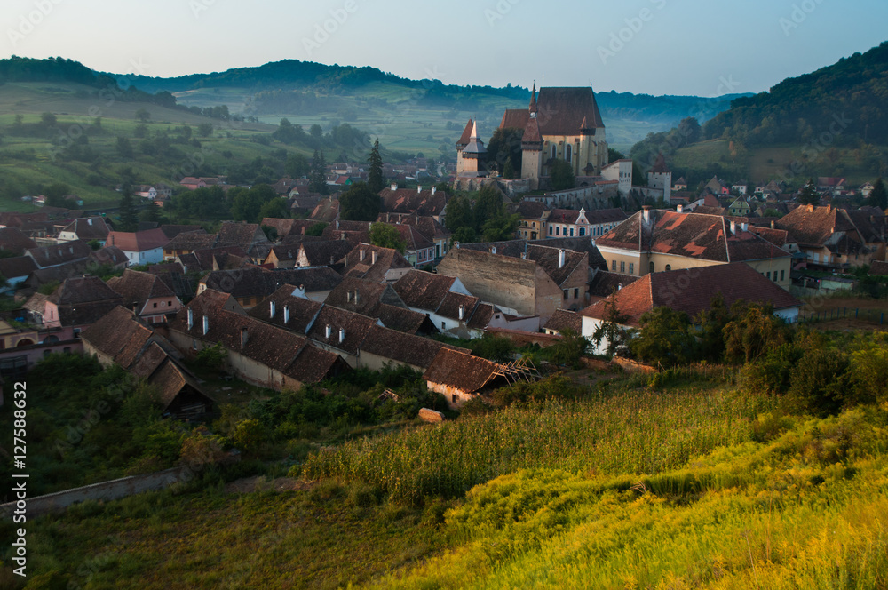 Beautiful Transylvanian saxon village and fortified church in morning sunlight