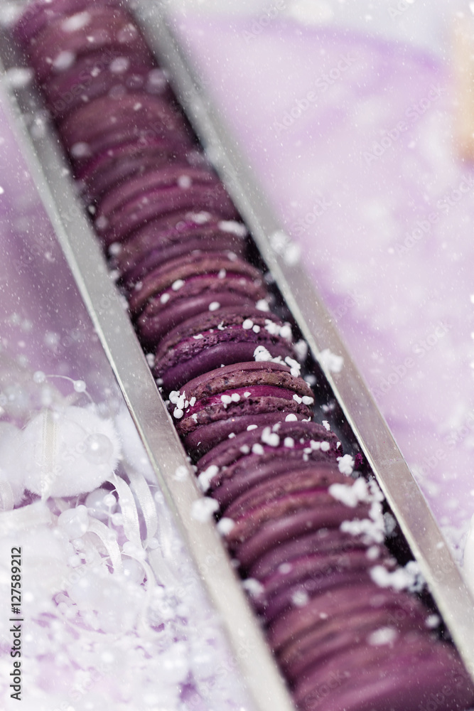 Purple macarons lying in silver box Purple macarons lying in silver box