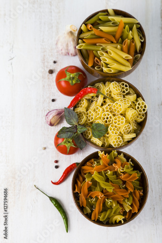 Pasta and ingredients: chili, tomatoes, basil, garlic and parsle