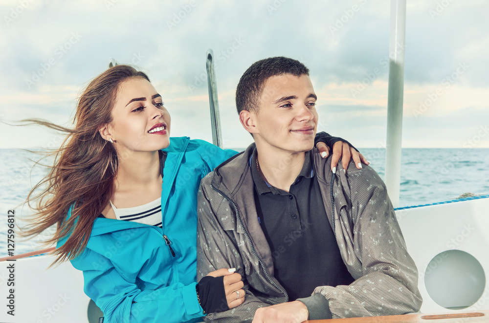 Happy couple woman and man, travel sailing on open sea