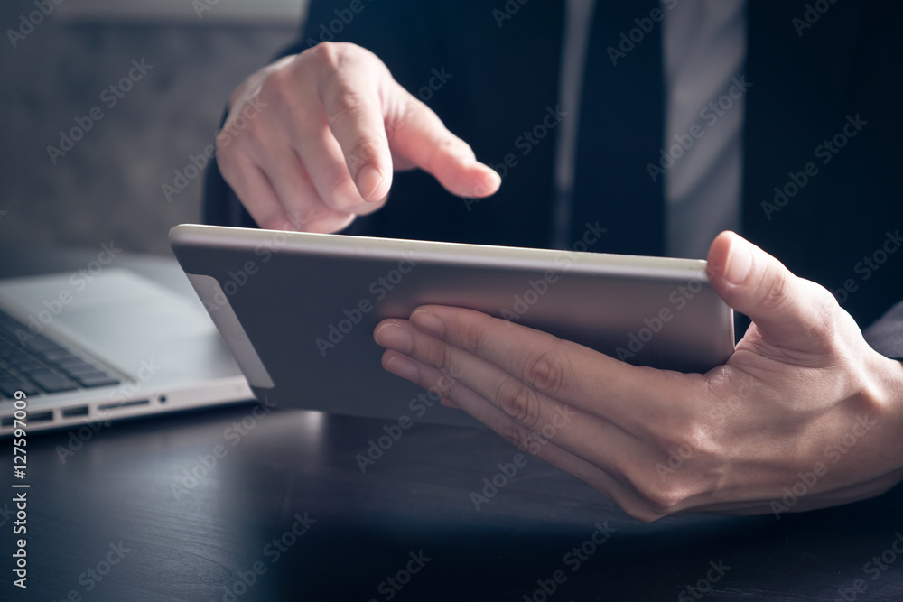 Close up of Businessman using tablet on the office desk. Close up of Businessman using tablet on the office desk.