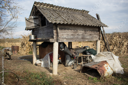 Wood shack junkyard in the field  photo