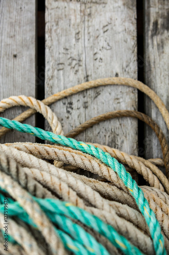 Rope lies on a wooden dock. Background.