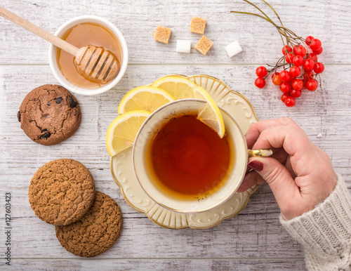 woman drinking tea with lemon closeup