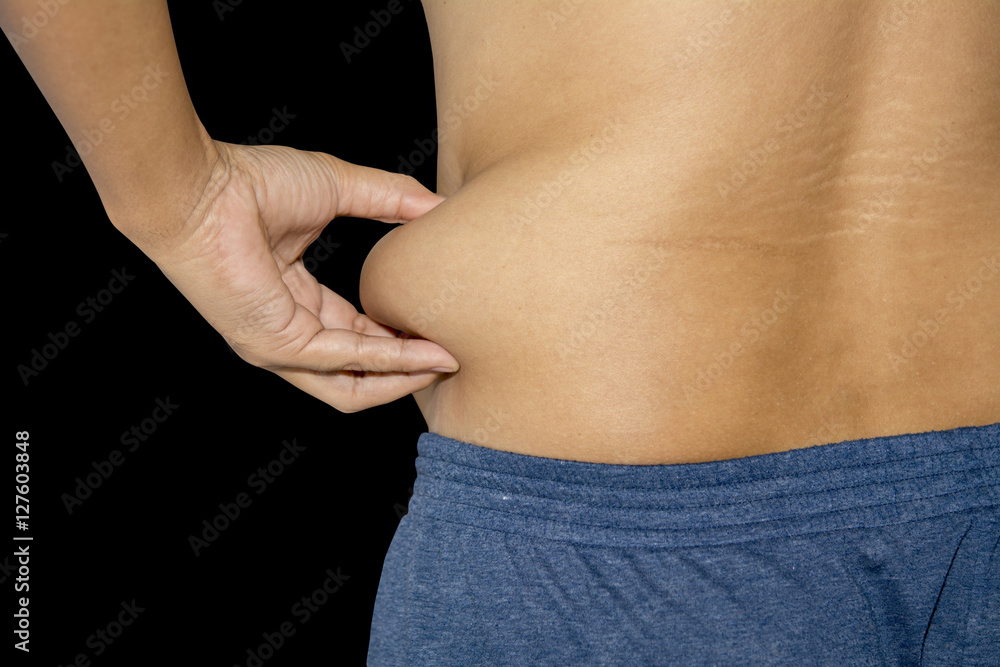 Naklejka premium Excess fat around the waist isolated on black