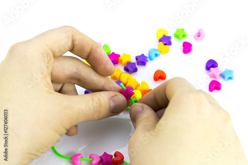 Making of handmade jewellery.multi colored beads