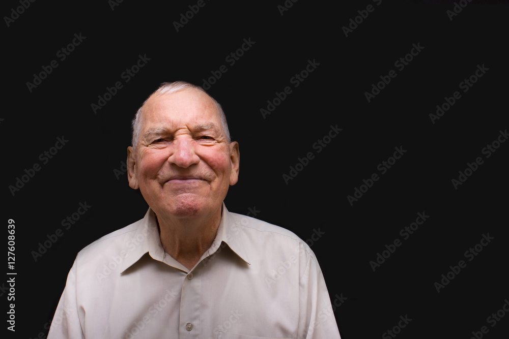 The happy elderly man on black background The happy elderly man on black background
