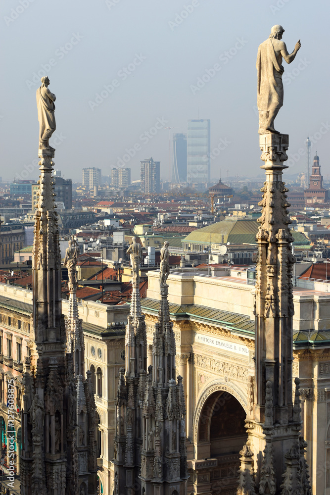 Gothic ornaments and sculptures of  Duomo overlooking the panorama of Milan and Gallery of Vittorio Emanuele