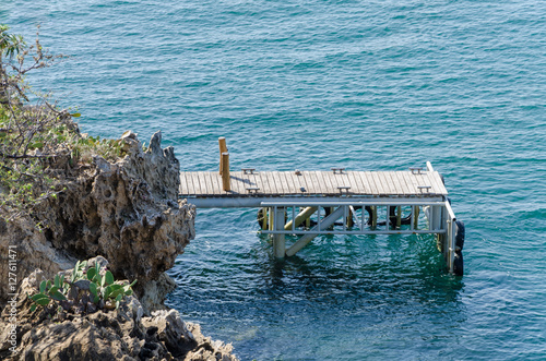 Wood and metal jetty for small boats at the coast of Angola photo