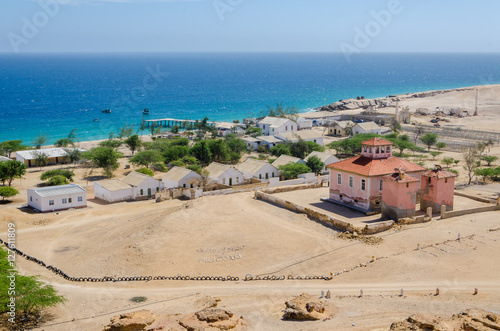 Small fishing village Mucuio with dominating Portuguese colonial building in Angola