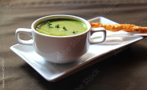 green cream soup of celery with cracker