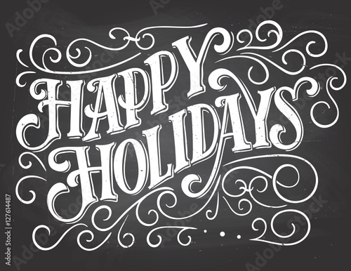 Happy holidays. Vintage hand lettering on blackboard background with chalk. Christmas typography