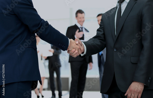 handshake between competitors before the start of business negot