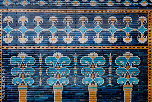 Ceramic coating with images of trees and patterns on the historical wall of Babylon, Pergamon Museum in Berlin photo