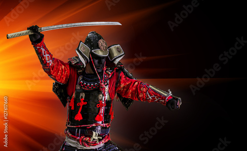 Samurai warrior with sword at sunset.