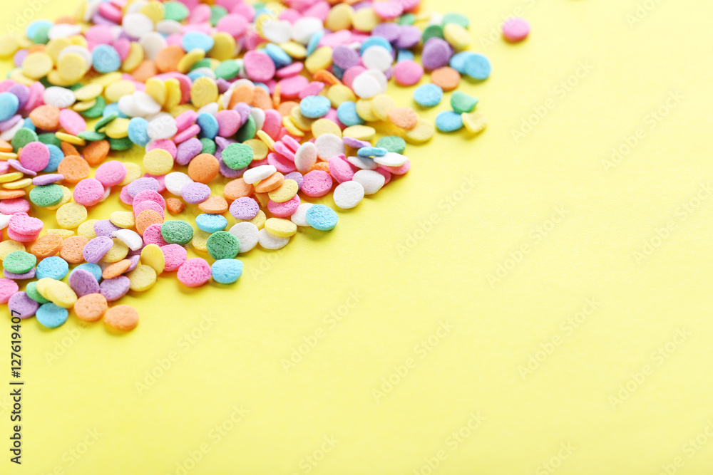Colorful sprinkles on a yellow background Colorful sprinkles on a yellow background