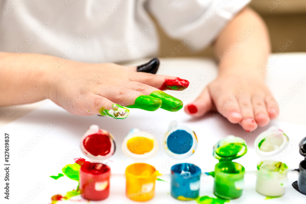 baby playing with colorful paints at home at the table baby playing with colorful paints at home at the table