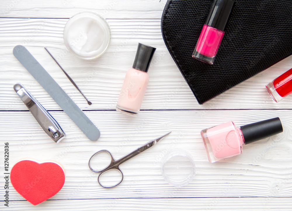 manicure set and nail polish on wooden background manicure set and nail polish on wooden background