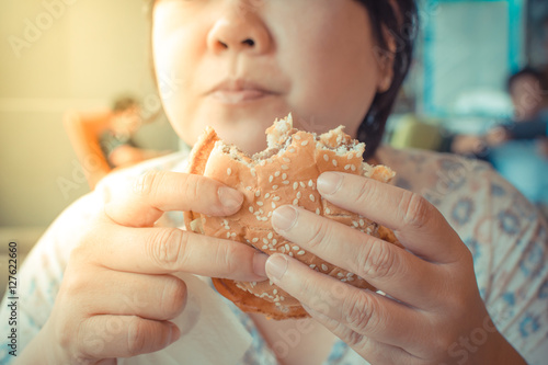 Asia woman eating a hamburger