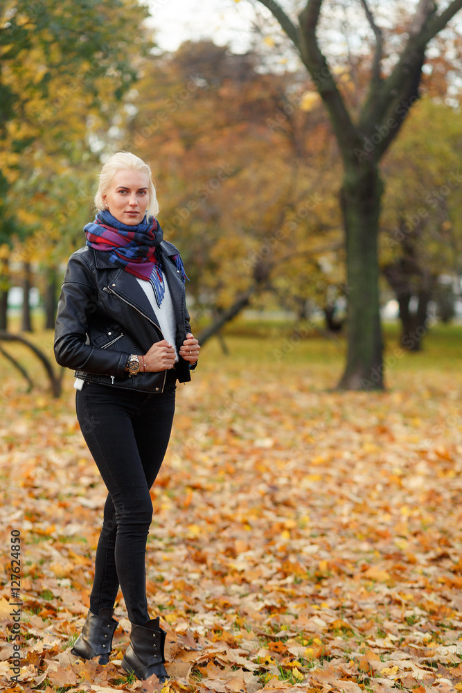 Portrait in full growth of young blonde woman walking outdoors Portrait in full growth of young blonde woman walking outdoors