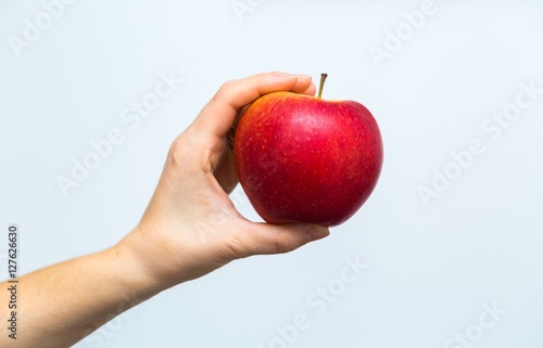 Apple holding by woman hands in close up